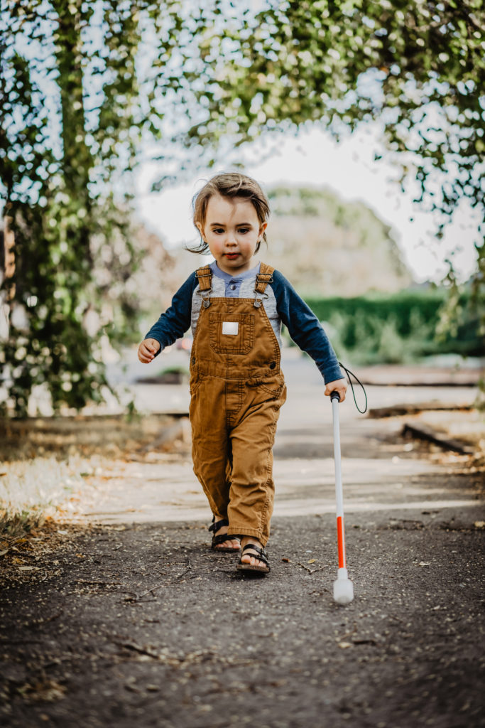 Boy walking with cane