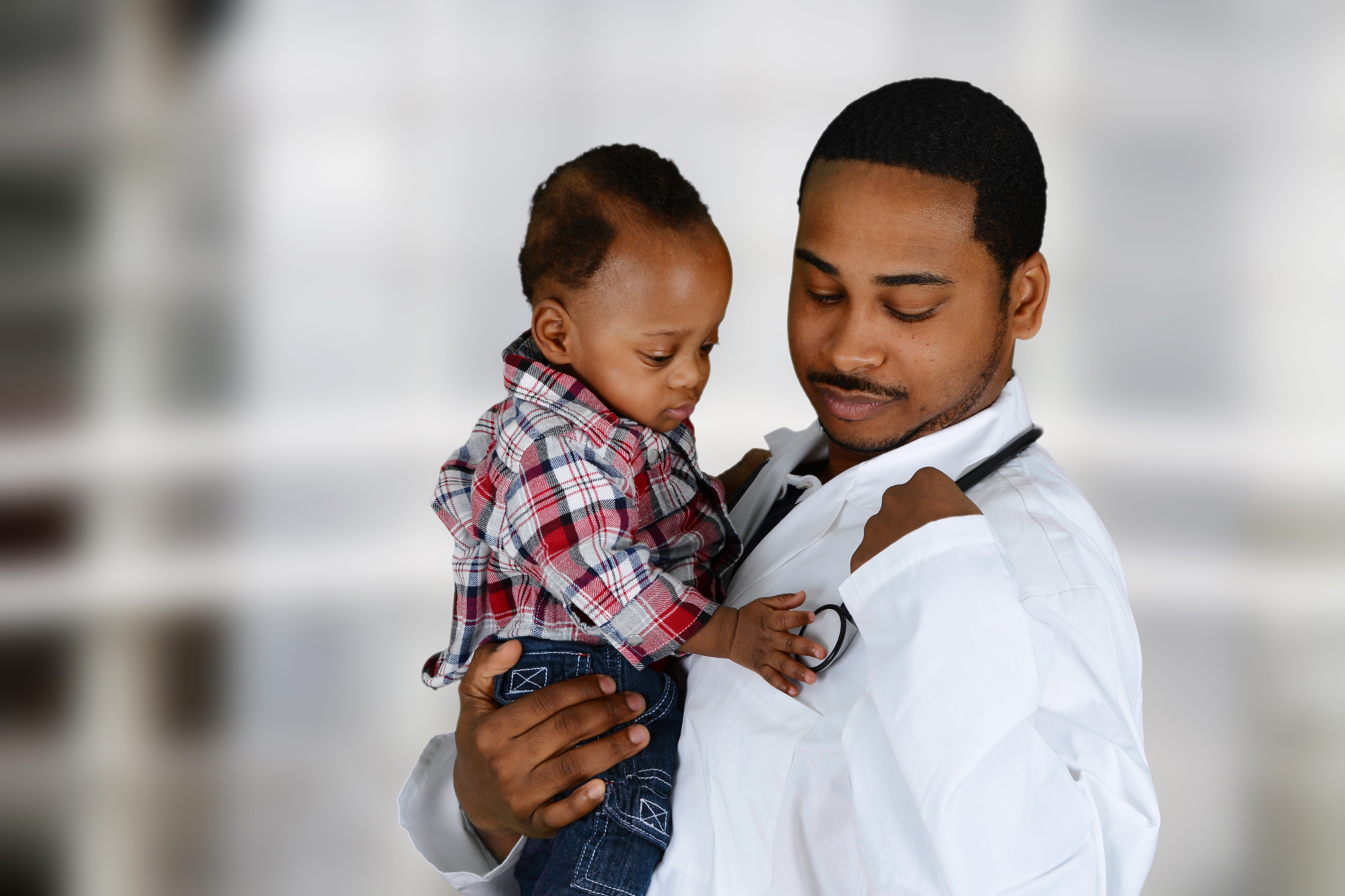 Doctor holding young child